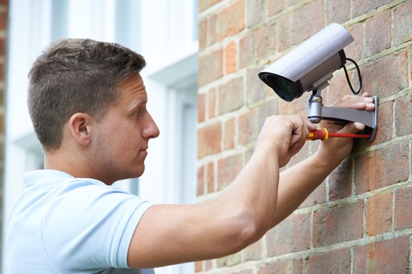 Man Installing Surveillance Camera in Fort Lauderdale, West Palm Beach, Davie, and Nearby Cities