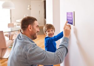 Man and son setting up a smart home security system in Jacksonville