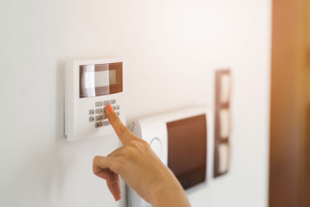 hands using a Security Alarms, Security Camera Systems, and Fire Alarm Systems in West Palm Beach, FL