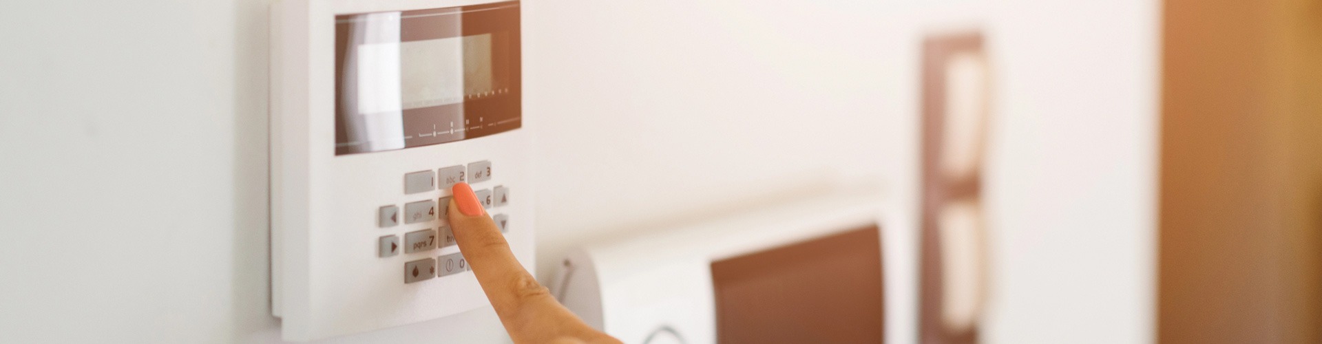 finger pressing buttons on keypad after Home Alarm Installation
